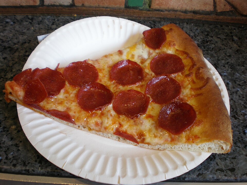 Pepperoni slice on a paper plate